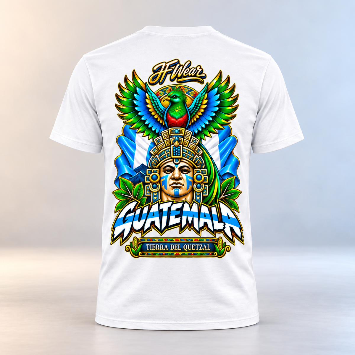 White short-sleeve t-shirt shown from the back, featuring a large colorful graphic print with a Guatemalan face in an ornate headdress, a green and red bird, blue wings, and the text 'IF Wear' and 'GUATEMALA TIERRA DEL QUETZAL'.